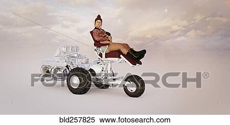 Stock Photography - Woman riding powerful luxury tricycle. Fotosearch