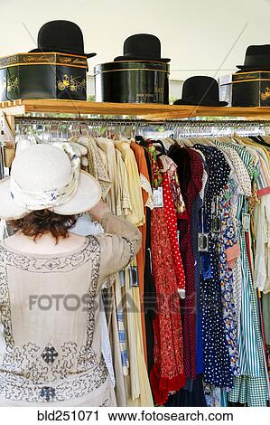 Woman shopping for dress in store View Large Photo Image Stock Image - Woman shopping for dress in store. Fotosearch