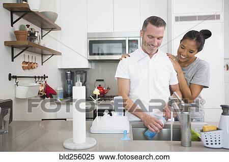 Woman watching man washing baby bottle View Large Photo Image Stock Photography - Woman watching man washing baby bottle. Fotosearch