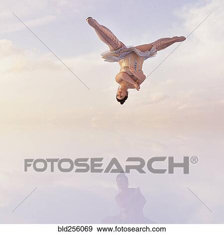 Stock Photo - Woman wearing corset and boots upside-down in clouds. Fotosearch