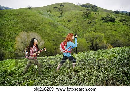 Stock Photo - Women hiking with walking sticks. Fotosearch