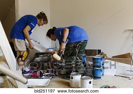 Women preparing to paint walls View Large Photo Image Stock Photo - Women preparing to paint walls. Fotosearch