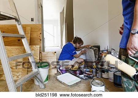 Stock Photo - Women preparing to paint walls. Fotosearch