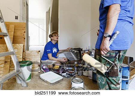 Stock Photo - Women preparing to paint walls. Fotosearch