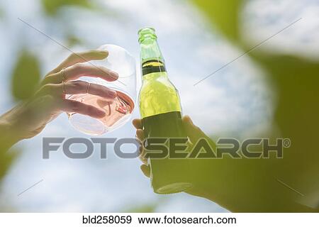 Women toasting with beer and wine View Large Photo Image Stock Photo - Women toasting with beer and wine. Fotosearch