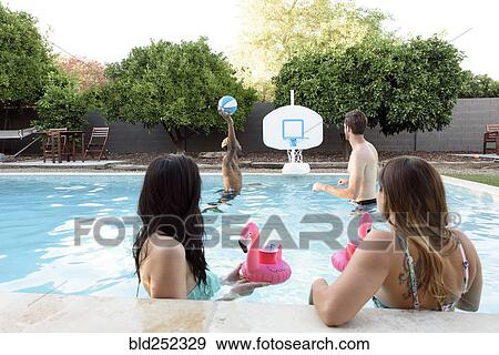 Women watching men playing basketball in swimming pool View Large Photo Image Stock Photo - Women watching men playing basketball in swimming pool. Fotosearch