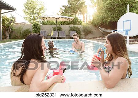 Women watching men playing in swimming pool View Large Photo Image Stock Image - Women watching men playing in swimming pool. Fotosearch