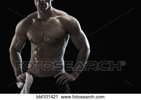 Stock Image - Bare chested Caucasian man with hands on hips. Fotosearch