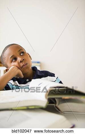 Stock Photo - Black boy studying. Fotosearch