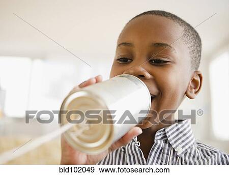 Black boy talking into tin can phone View Large Photo Image Stock Photo - Black boy talking into tin can phone. Fotosearch