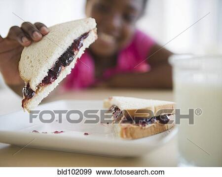 Black girl eating peanut butter and jelly sandwich View Large Photo Image Stock Photo - Black girl eating peanut butter and jelly sandwich. Fotosearch