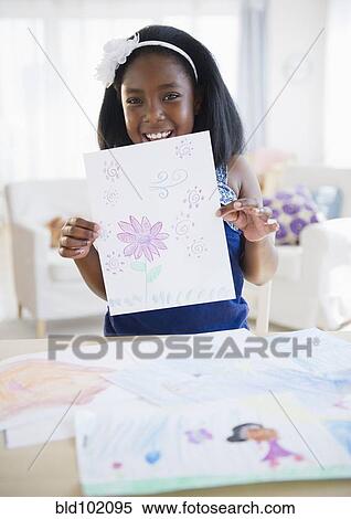 Stock Photography - Black girl holding drawing. Fotosearch