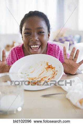 Stock Photograph - Black girl holding empty plate. Fotosearch