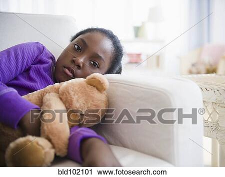 Black girl laying on sofa with teddy bear View Large Photo Image Stock Image - Black girl laying on sofa with teddy bear. Fotosearch