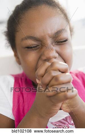 Stock Photo - Black girl praying. Fotosearch