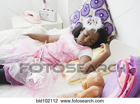 Stock Image - Black girl sleeping in fairy costume. Fotosearch