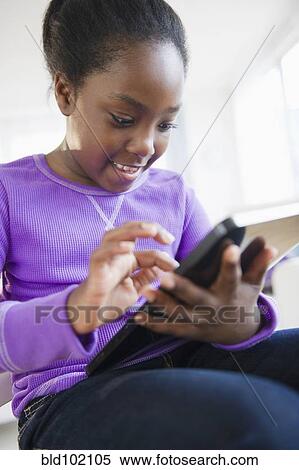 Black girl using digital tablet View Large Photo Image Stock Photography - Black girl using digital tablet. Fotosearch