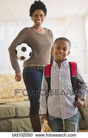 Stock Image - Black mother and son getting ready for the day. Fotosearch