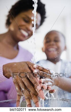 Black mother and son washing hands View Large Photo Image Stock Image - Black mother and son washing hands. Fotosearch