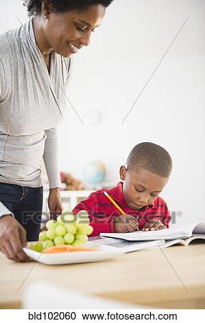 Black mother helping son with homework View Large Photo Image Stock Image - Black mother helping son with homework. Fotosearch