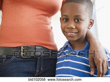 Stock Photo - Black mother hugging son. Fotosearch
