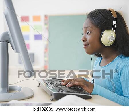 Stock Photography - Black student using computer in classroom. Fotosearch