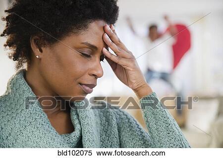 Black woman with headache and playful son in background View Large Photo Image Stock Photography - Black woman with headache and playful son in background. Fotosearch