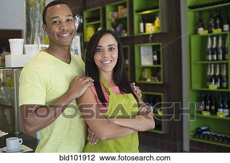 Stock Image - Business owners standing in shop. Fotosearch