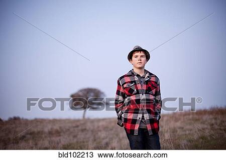 Caucasian boy standing in field View Large Photo Image Stock Image - Caucasian boy standing in field. Fotosearch