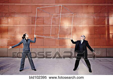 Stock Photography - Caucasian business people lifting metal box. Fotosearch