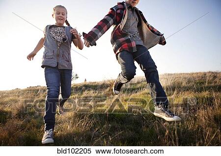 Caucasian children running in field View Large Photo Image Stock Photography - Caucasian children running in field. Fotosearch