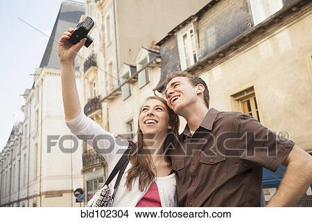 Picture - Caucasian couple taking self-portrait. Fotosearch