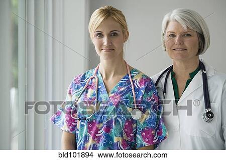 Picture - Caucasian doctor and nurse standing together. Fotosearch