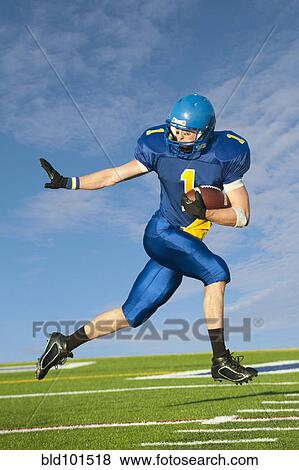 Caucasian football player running with football View Large Photo Image Stock Photo - Caucasian football player running with football. Fotosearch