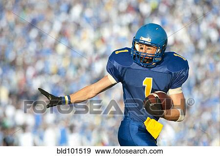 Stock Photo - Caucasian football player running with football. Fotosearch