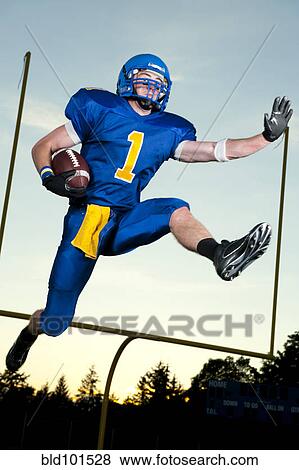Caucasian football player running with football View Large Photo Image Stock Photo - Caucasian football player running with football. Fotosearch