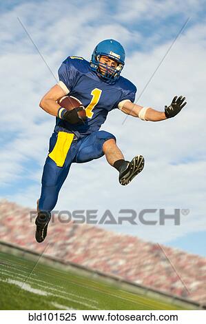 Caucasian football player running with football View Large Photo Image Stock Photography - Caucasian football player running with football. Fotosearch
