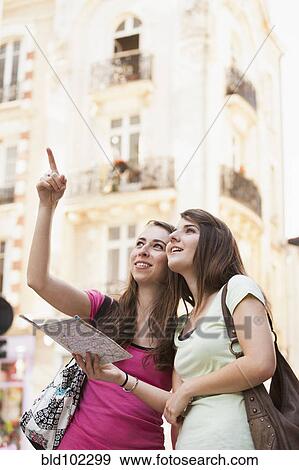 Stock Photo - Caucasian friends sightseeing. Fotosearch