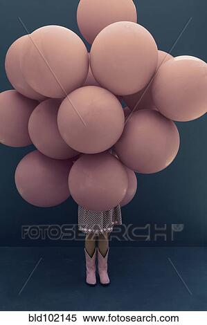 Stock Photography - Caucasian girl holding large balloons. Fotosearch