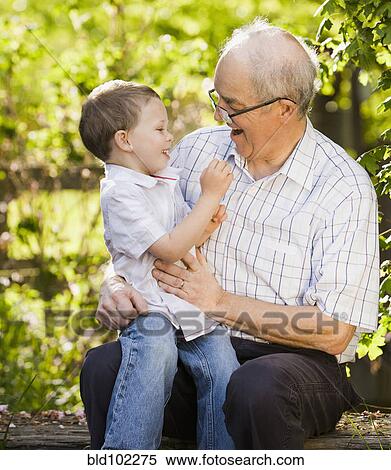 Caucasian grandfather talking with grandson View Large Photo Image Stock Photography - Caucasian grandfather talking with grandson. Fotosearch