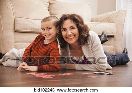 Caucasian grandmother and granddaughter playing cards on floor View Large Photo Image Stock Image - Caucasian grandmother and granddaughter playing cards on floor. Fotosearch