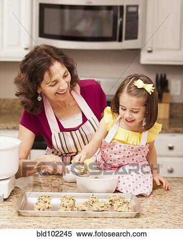 Caucasian grandmother and granddaughter baking cookies View Large Photo Image Stock Photography - Caucasian grandmother and granddaughter baking cookies. Fotosearch