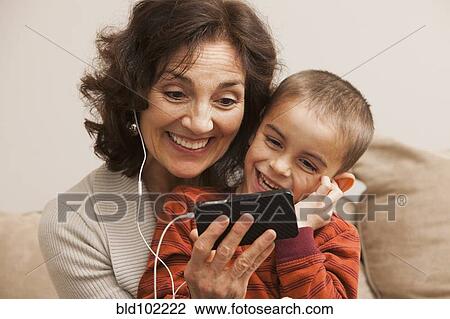 Caucasian grandmother and grandson listening to mp3 player View Large Photo Image Stock Image - Caucasian grandmother and grandson listening to mp3 player. Fotosearch