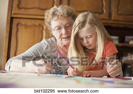 Caucasian grandmother helping granddaughter with homework View Large Photo Image Stock Photography - Caucasian grandmother helping granddaughter with homework. Fotosearch