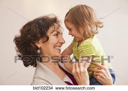 Caucasian grandmother holding granddaughter View Large Photo Image Picture - Caucasian grandmother holding granddaughter. Fotosearch