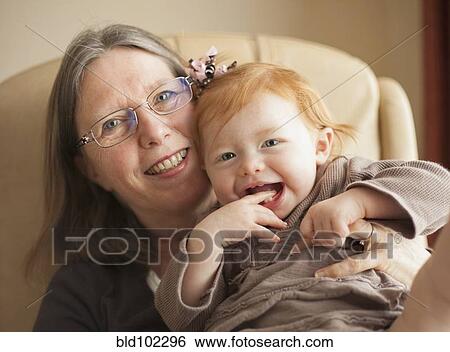 Caucasian grandmother holding granddaughter View Large Photo Image Stock Photograph - Caucasian grandmother holding granddaughter. Fotosearch