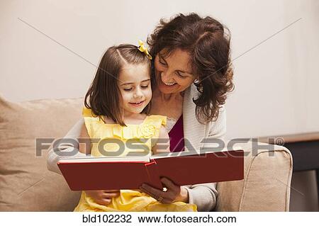 Caucasian grandmother reading book to granddaughter View Large Photo Image Stock Image - Caucasian grandmother reading book to granddaughter. Fotosearch