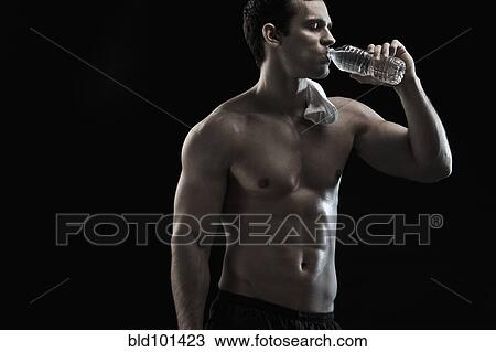 Caucasian man drinking water after exercise View Large Photo Image Stock Image - Caucasian man drinking water after exercise. Fotosearch