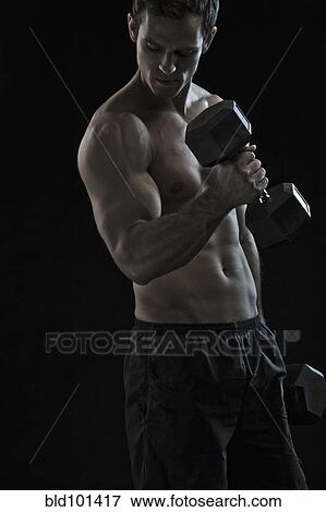 Stock Photo - Caucasian man exercising with hand weights. Fotosearch