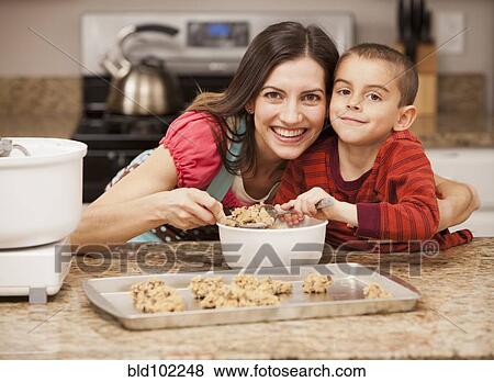 Stock Photo - Caucasian mother and son baking cookies. Fotosearch